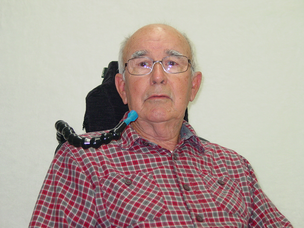 Man in Wheelchair using the Hydration Backpack with Drinking Tube Positioning