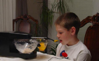 Child using the Mealtime Partner Robotic Feeding Device